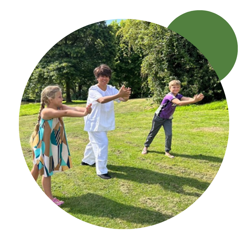 helen and children doing tai chi, outside<br />
